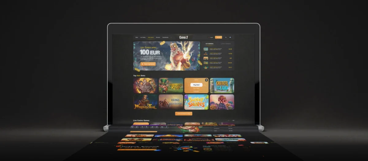 Gambit casino homepage on a laptop with a First Deposit Bonus 100 EUR banner, a Top Winners list and a grid of Top Hot Slots